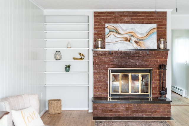 detailed view of wood finished floors, ornamental molding, a baseboard heating unit, a fireplace, and built in features