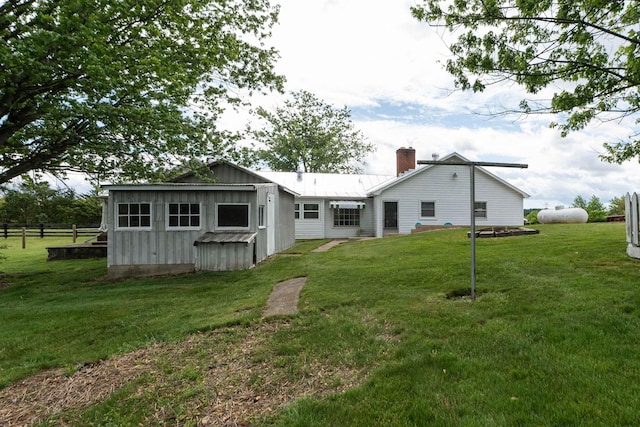 rear view of property with a chimney