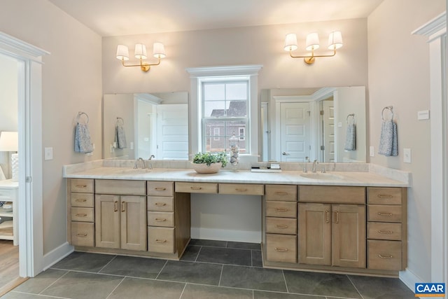 full bath featuring baseboards, tile patterned flooring, double vanity, and a sink