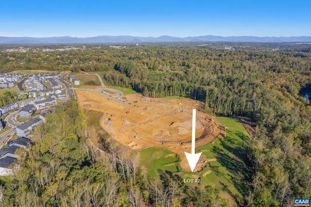 bird's eye view featuring a forest view and a mountain view