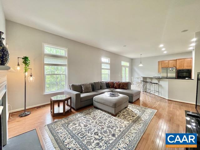 151 Deer Run Dr, Zion Crossroads, VA 22942 - living area featuring light wood-style floors, a fireplace with flush hearth, recessed lighting, and baseboards
