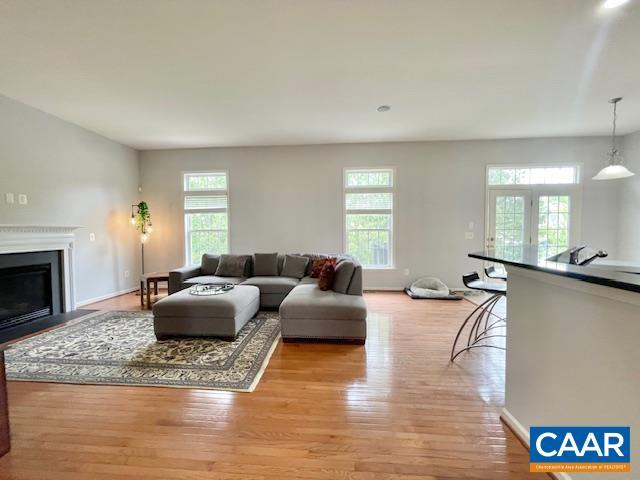 151 Deer Run Dr, Zion Crossroads, VA 22942 - living area with light wood-style flooring, a fireplace with flush hearth, and baseboards
