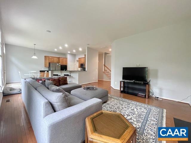 151 Deer Run Dr, Zion Crossroads, VA 22942 - living area with wood finished floors, recessed lighting, stairway, and baseboards