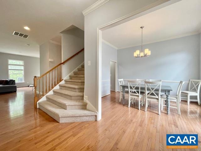 151 Deer Run Dr, Zion Crossroads, VA 22942 - dining space with crown molding, hardwood / wood-style flooring, stairway, a chandelier, and baseboards