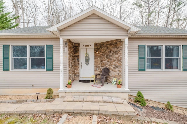 view of front of property with a porch and roof with shingles