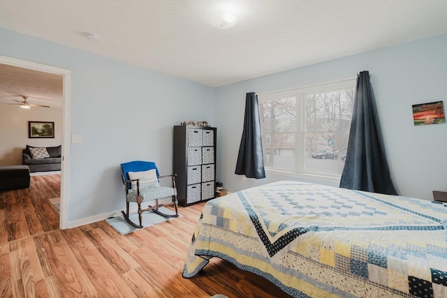 bedroom with baseboards and wood finished floors