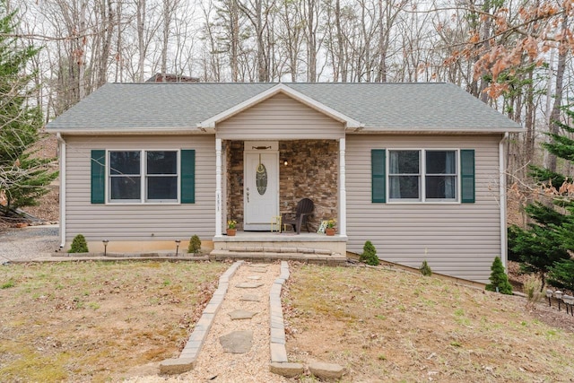 single story home with a shingled roof
