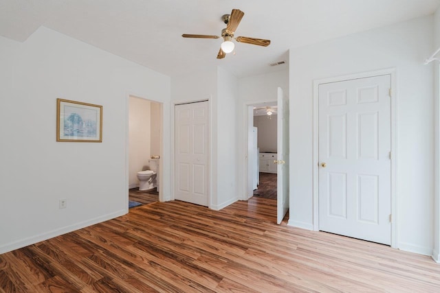 unfurnished bedroom featuring light wood-type flooring, visible vents, a ceiling fan, connected bathroom, and baseboards