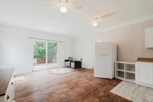 unfurnished room featuring ceiling fan, crown molding, and wood finished floors