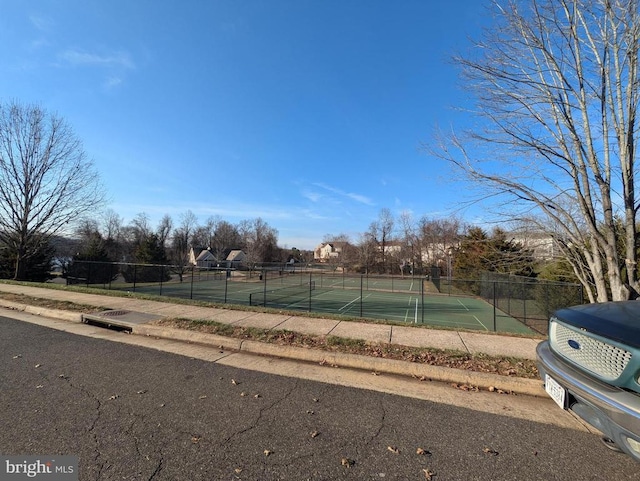 view of tennis court featuring fence