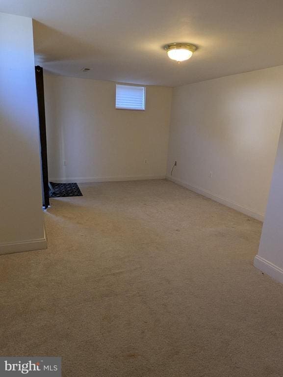 basement with light colored carpet and baseboards