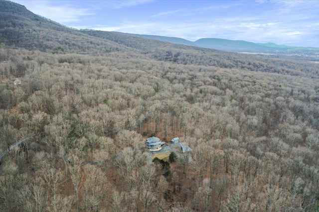 birds eye view of property with a wooded view and a mountain view