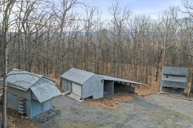 drone / aerial view with a wooded view