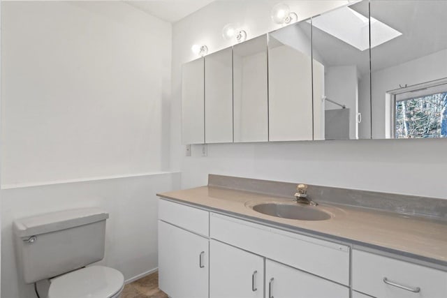 bathroom featuring toilet and vanity