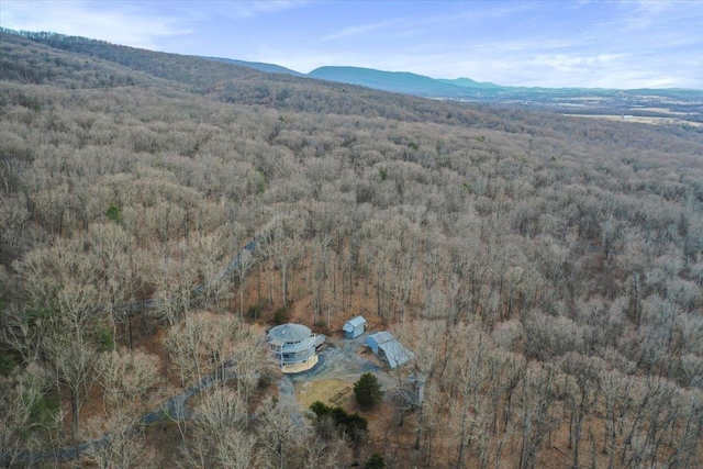 aerial view with a wooded view and a mountain view