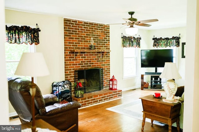 13498 Chesterfield Ln, Culpeper, VA 22701 - living room with a ceiling fan, wood finished floors, a brick fireplace, and baseboards