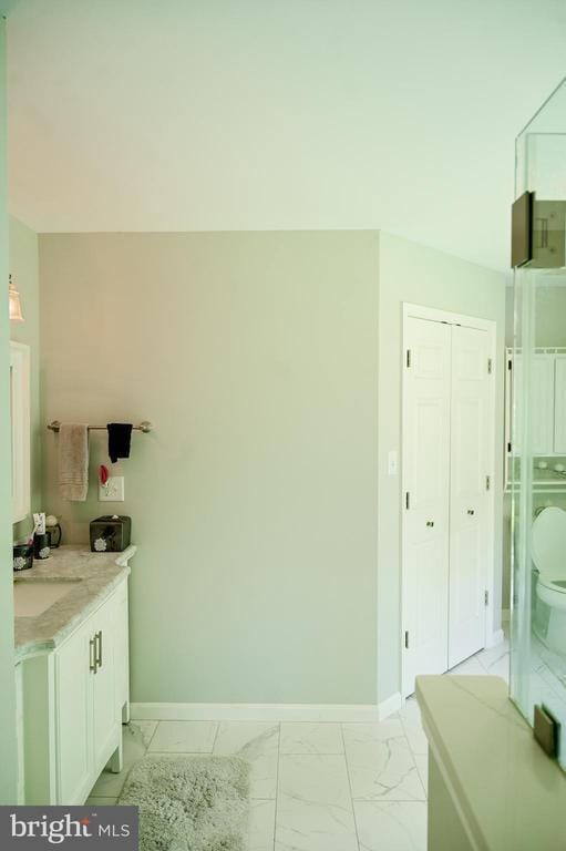 13498 Chesterfield Ln, Culpeper, VA 22701 - bathroom featuring marble finish floors, baseboards, toilet, and vanity