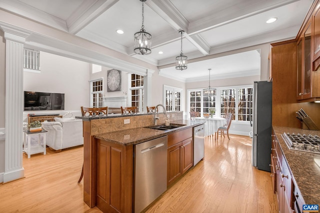 1880 Graham Ct, Keswick, VA 22947 - kitchen featuring a sink, a chandelier, brown cabinets, and appliances with stainless steel finishes