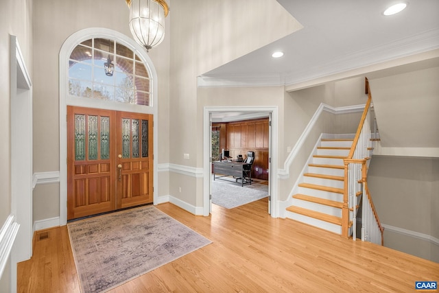 1880 Graham Ct, Keswick, VA 22947 - foyer with wood finished floors, a notable chandelier, crown molding, stairway, and visible vents