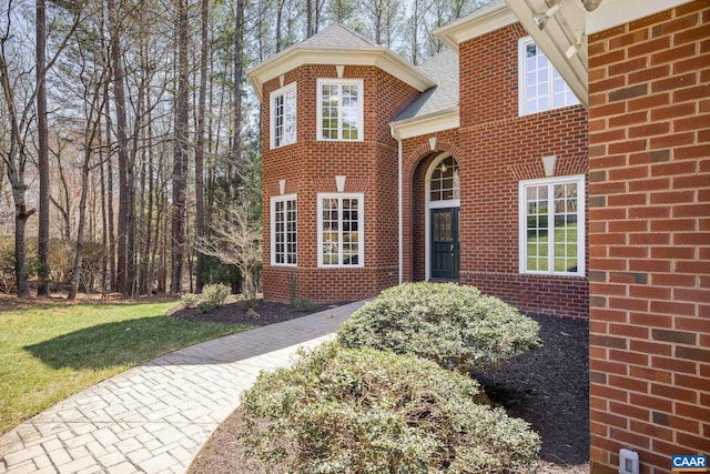 1880 Graham Ct, Keswick, VA 22947 - view of front facade with a shingled roof, brick siding, and a front yard