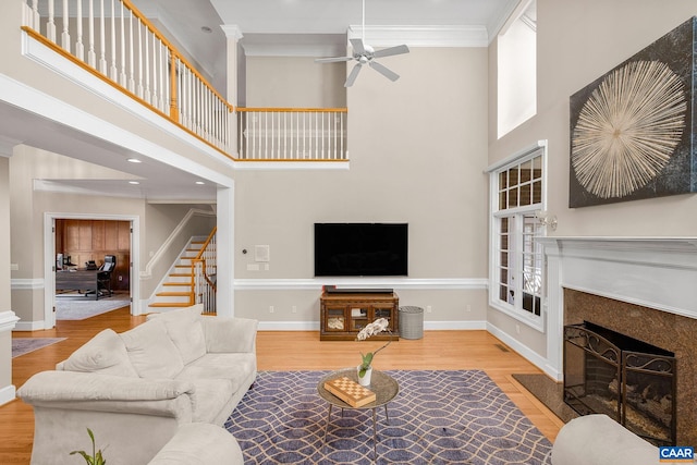 1880 Graham Ct, Keswick, VA 22947 - living room with stairs, wood finished floors, a towering ceiling, a ceiling fan, and a fireplace with flush hearth