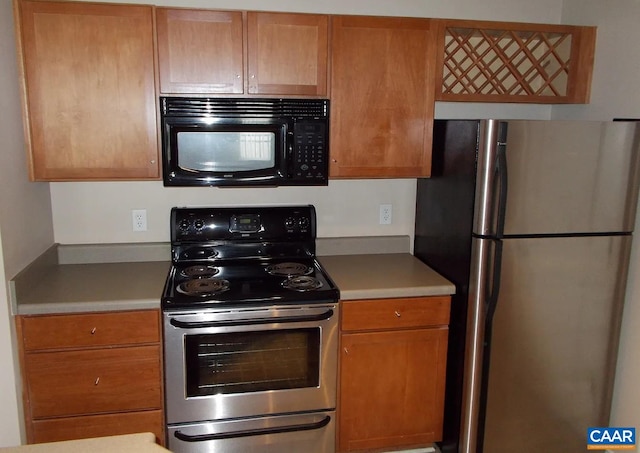 kitchen with appliances with stainless steel finishes and brown cabinetry