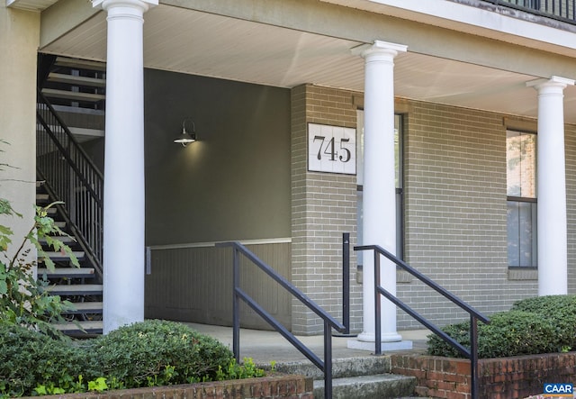 doorway to property featuring brick siding