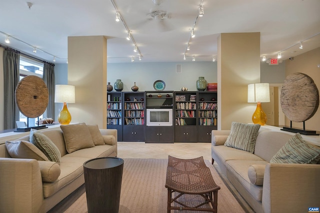 tiled living area featuring rail lighting