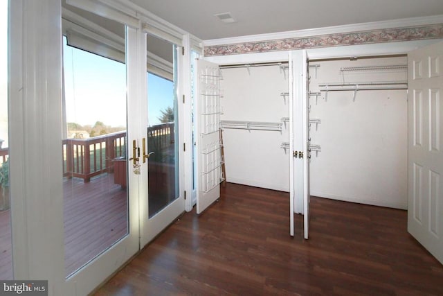doorway featuring wood finished floors, french doors, and ornamental molding