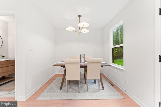 228 Poplar Dr, Louisa, VA 23093 - dining area featuring a chandelier, wood finished floors, and baseboards