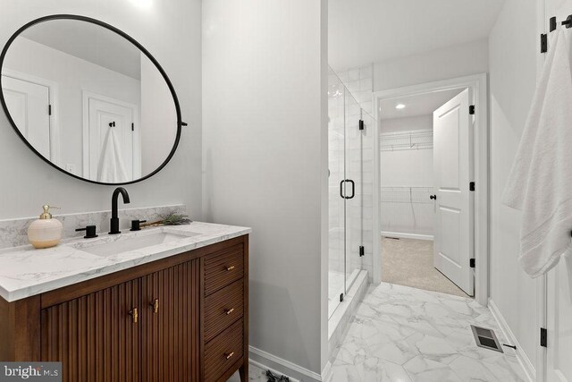 228 Poplar Dr, Louisa, VA 23093 - bathroom with marble finish floors, vanity, a stall shower, a spacious closet, and baseboards