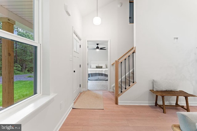 228 Poplar Dr, Louisa, VA 23093 - foyer featuring high vaulted ceiling, healthy amount of natural light, a ceiling fan, stairway, and wood finished floors