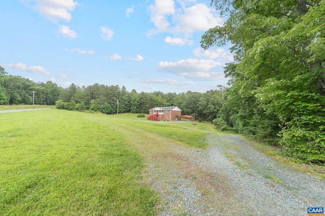 3590 Mountain Hill Rd, Palmyra, VA 22963 - view of green lawn featuring driveway, a forest view, and a barn