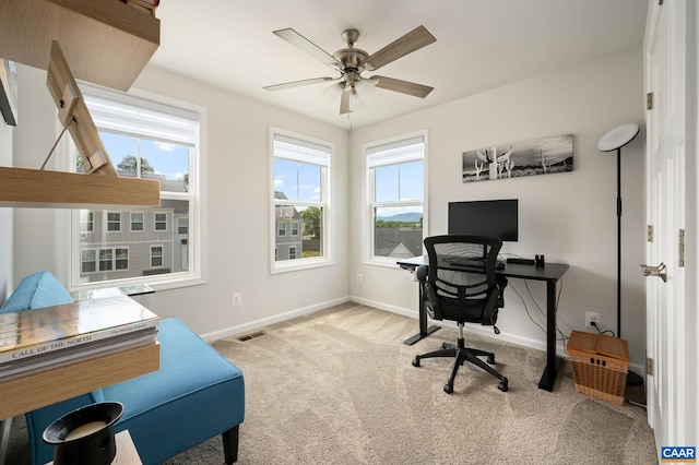 home office featuring baseboards, carpet, and a ceiling fan