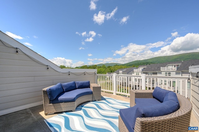 deck with a mountain view and an outdoor hangout area