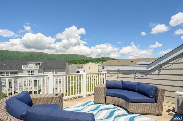 wooden deck with an outdoor hangout area, a mountain view, and a residential view