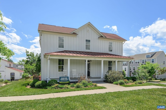view of front of house with board and batten siding, a porch, and a standing seam roof