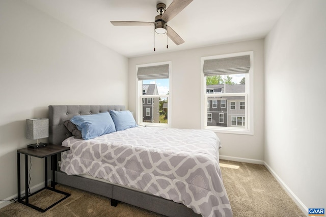 carpeted bedroom with baseboards and ceiling fan