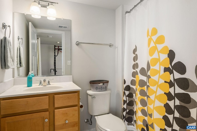 bathroom featuring toilet, vanity, and a shower with shower curtain