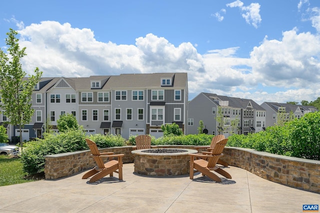 view of patio / terrace featuring a fire pit and a residential view