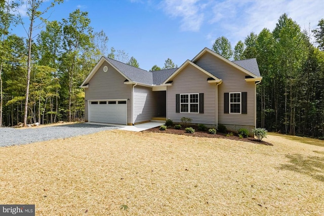 ranch-style home with a garage, driveway, and a front lawn