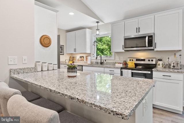 1875 Oneals Rd, Madison, VA 22727 - kitchen with stainless steel appliances, a breakfast bar area, a sink, white cabinets, and light stone countertops