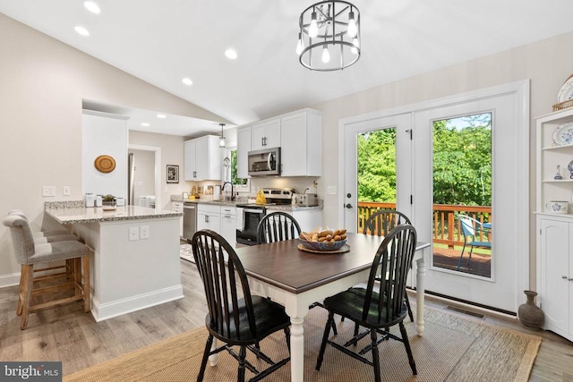 1875 Oneals Rd, Madison, VA 22727 - dining space featuring light wood finished floors, lofted ceiling, recessed lighting, a chandelier, and baseboards