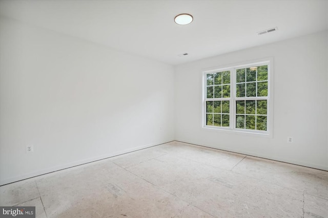 spare room with baseboards