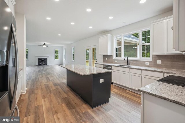 Beaver Dam Rd, Jeffersonton, VA 22724 - kitchen with stainless steel fridge with ice dispenser, a sink, open floor plan, backsplash, and light wood-style floors