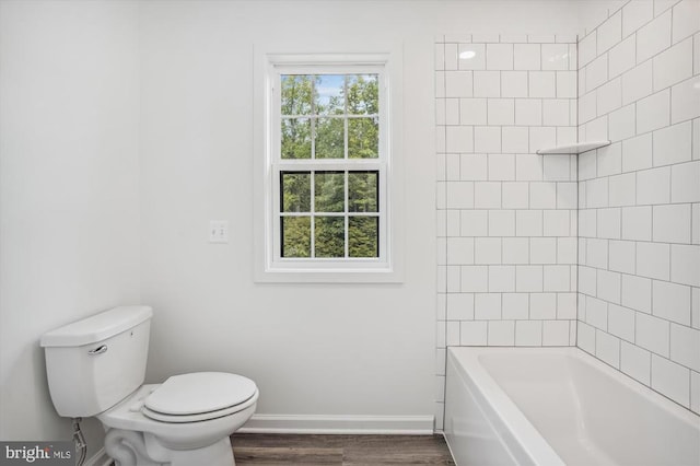 full bathroom with baseboards, toilet, and wood finished floors