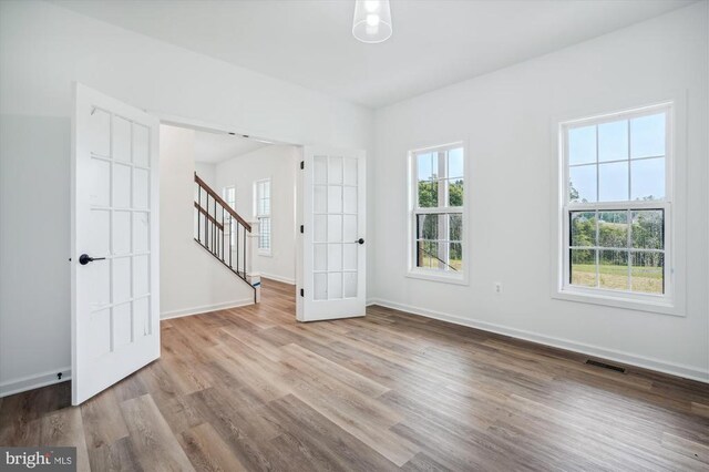 Beaver Dam Rd, Jeffersonton, VA 22724 - spare room with wood finished floors, baseboards, and stairway