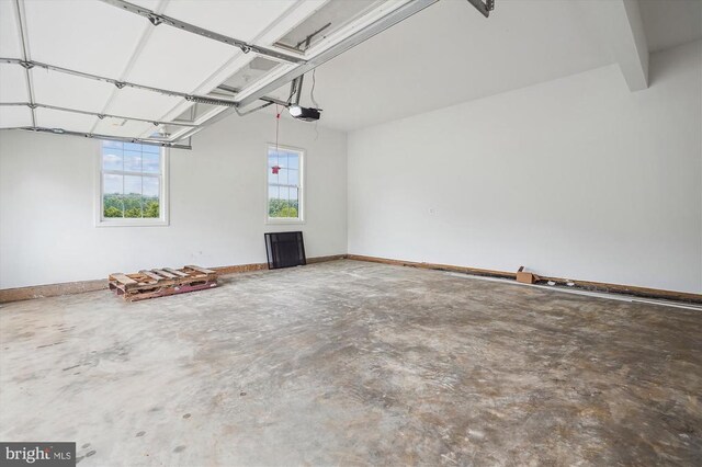 garage with a garage door opener and baseboards