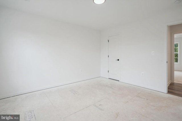 spare room with baseboards