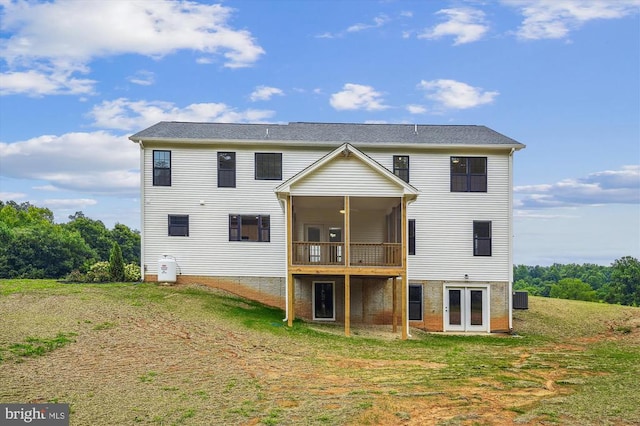 back of property featuring a lawn, french doors, central AC, and a deck
